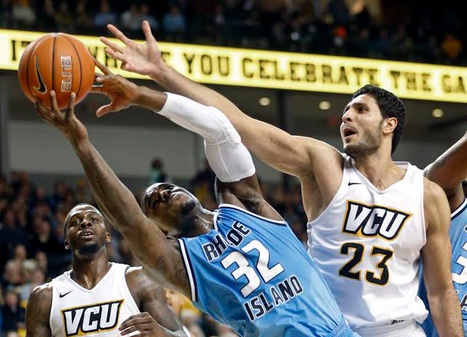 URI's Jared Terrell grabs the ball away from VCU's Ahmed Hamdy-Mohamed (23).