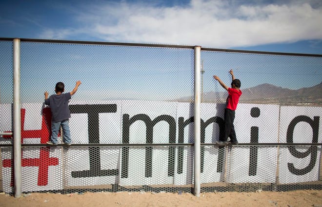 Two small boys balance themselves on the rail of a border fence during an event organized by the Border Network for Human Rights, on the outskirts of Ciudad Juarez, Mexico, Monday, Feb. 15, 2016. Pope Francis will conclude his weeklong Mexico trip with a visit to Ciudad Juarez where he will meet with Mexican workers, grassroots groups and employers in an encounter where he'll likely repeat his mantra on the need for dignified work for all and “land, labor and lodging.” (AP Photo/Ivan Pierre Aguirre)