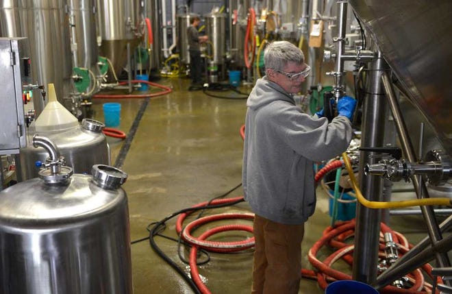 Brewery works work at the Creature Comforts brewery on Monday, Feb. 16, 2016 in Athens, Ga. (Richard Hamm/Staff) OnlineAthens / Athens Banner-Herald