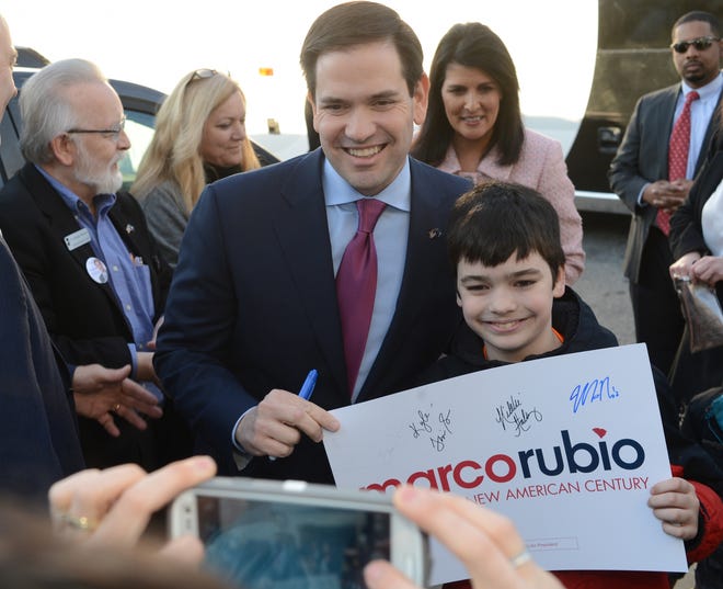Republican presidential candidate Marco Rubio poses for a picture with Kyle Williams, 10, during a campaign stop at The Beacon in Spartanburg on Thursday. Rubio was accompanied by U.S. Sen. Tim Scott and Gov. Nikki Haley, background right. JOHN BYRUM/john.byrum@shj.com