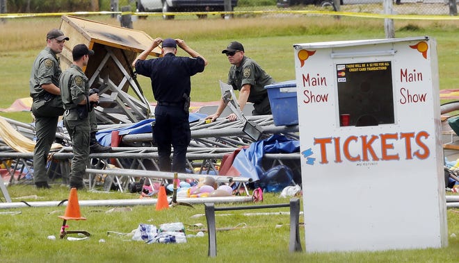 Investigators at the scene of a circus tent that collapsed, killing a father and his 6-year-old daughter in Lancaster on Aug. 3, 2015. AP Photo/Jim Cole, file