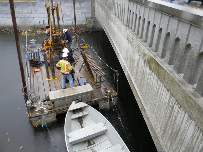 In this 2014 file photo, crews drill into the bottom of the Exeter River near Great Bridge in Exeter as design work began on plans to remove Great Dam.