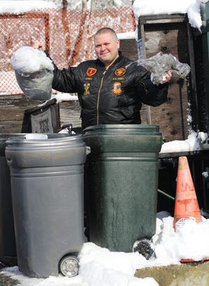 Bridgewater Town Councilor John Norris holds up some plastic bags dropped off at the transfer station. Wicked Local Photo/Charlene A. McNeil