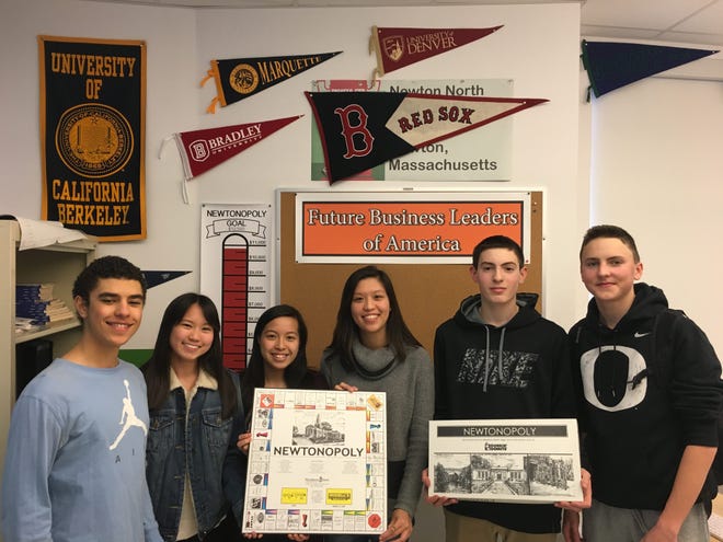 Members of the Future Business Leaders of America club at Newton North holding the old Newtonopoly board. Wicked Local photo/Jonathan Dame