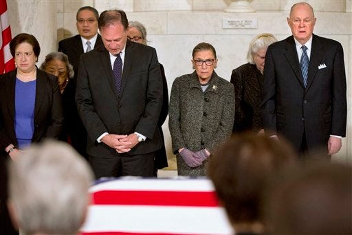 Supreme Court Justices, from left, Elena Kagan, Samuel Anthony Alito, Jr., Ruth Bader Ginsburg, and Anthony Kennedy participate in prayers at a private ceremony in the Great Hall of the Supreme Court in Washington, Friday, Feb. 19, 2016, where late Supreme Court Justice Antonin Scalia lies in repose.