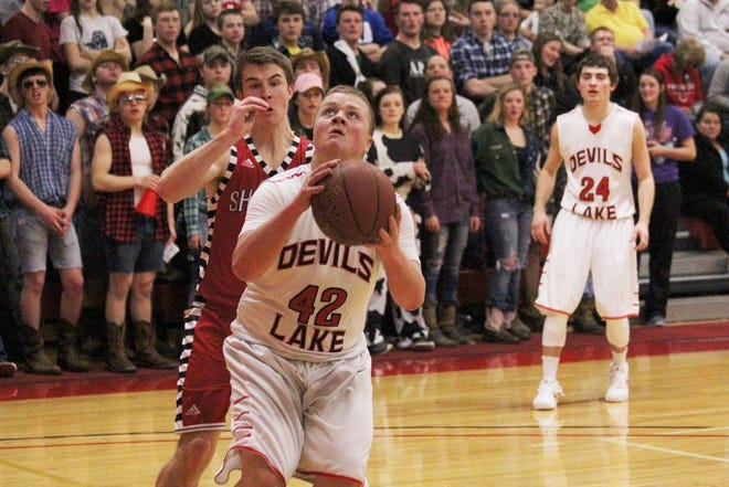 Hunter Fee gets between his defender and the basket for a layup in the first half of Devils Lake's game against Fargo Shanley. The Firebirds and Deacons went back and forth, but Shanley got the last laugh in a 74-73 win.
