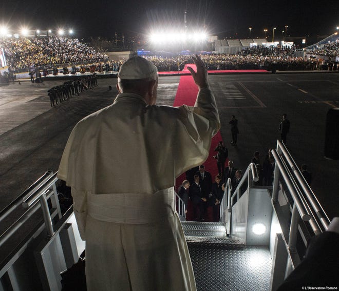 In this Wednesday, Feb. 17, 2016 photo, Pope Francis waves as he board his flight to Rome during the farewell ceremony at Ciudad Juarez, Mexico. (L'Osservatore Romano/Pool Photo via AP)