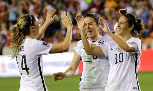 United States' Carli Lloyd (10) celebrates with Kelley O'Hara, center, and Morgan Brian (14) after scoring a goal against Trinidad and Tobago during the first half of a CONCACAF Olympic women's soccer qualifying championship semifinal Friday, Feb. 19, 2016, in Houston.