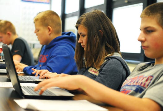 Eighth grade students at Edison Junior High School learn on Chromebooks Thursday. The school recently received a grant that enabled them to buy 60 more of the devices.
