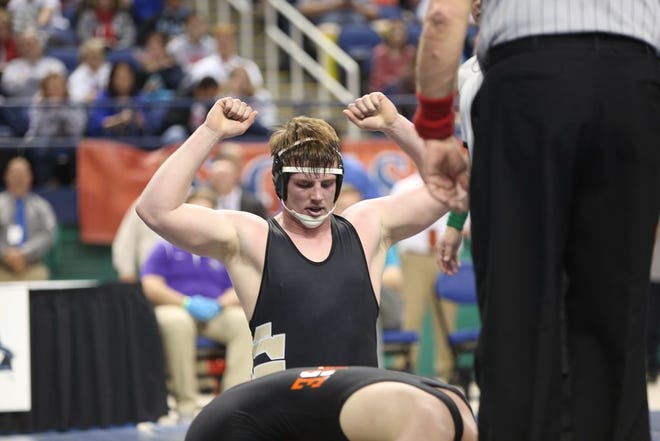 North Gaston senior Lathan Bumgarner celebrates his individual state title in the 220-pound weight class at the Greensboro Coliseum Saturday.