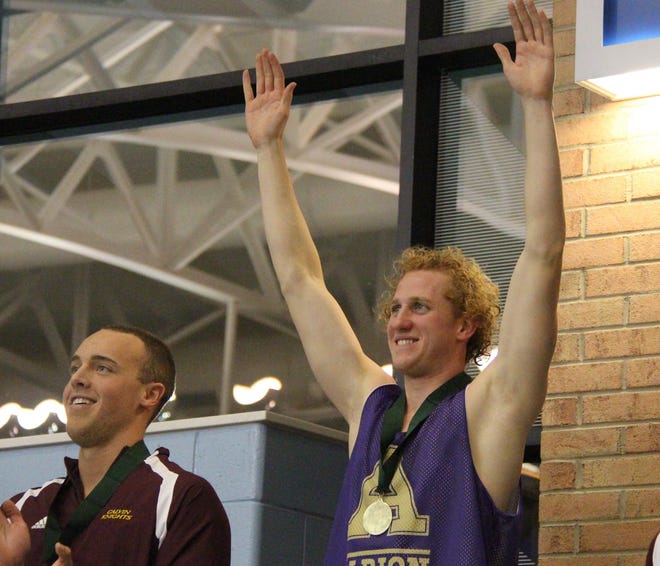 Albion's Derek Bosko, of Holland, stands on the podium after winning the MIAA title in the 100 freestyle Saturday, Feb. 20, at Calvin. Dan D'Addona/Sentinel staff