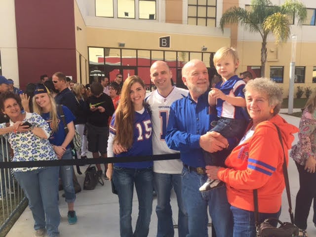 Nicole (wearing "15" jersey), Darren Cunningham, and their son Jaxon, being held by grandparents Bob and Rosetta Shobe, drove from Sanford to Real Life Church in Clermont Sunday to hear Tim Tebow speak.
