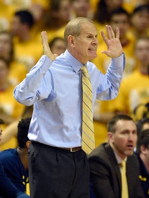 Michigan head coach John Beilein gestures during the first half of an NCAA college basketball game against Maryland, Sunday, Feb. 21, 2016, in College Park, Md. (AP Photo/Nick Wass)