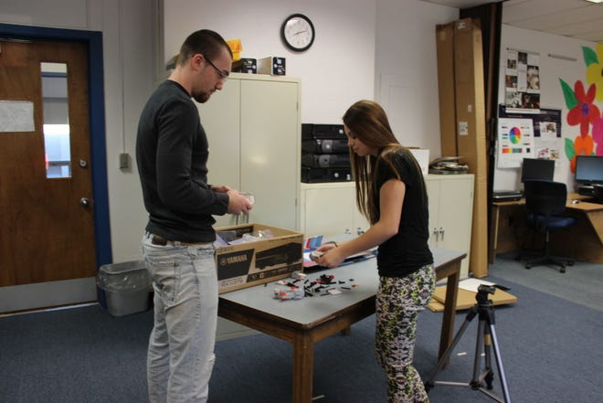 Senior Carson Haury and junior Sara Schlickau work on putting a Lego robot together in the new Emerging Technologies class at Pretty Prairie High School.
