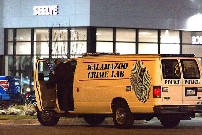 An officer with the Kalamazoo Crime Lab leaves the scene of a random shooting on Sunday, Feb. 21, 2016 in Kalamazoo. Jason Dalton of Kalamazoo County was arrested early Sunday in downtown Kalamazoo following a massive manhunt after several victims were shot at random. (Bryan Bennett/Kalamazoo Gazette-MLive Media Group via AP) LOCAL TELEVISION OUT; LOCAL RADIO OUT; MANDATORY CREDIT