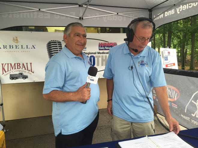 Tony Khoury assisting WMRC's Rick Michaels, on air at the 2015 WMRC Radiothon to benefit the Oliva Fund at Milford Regional Medical Center. Courtesy Photo
