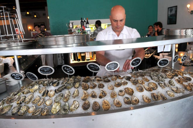 Oyster shucker Mike Famico prepares a variety of oysters for patrons at the Franklin Oyster House in Portsmouth. Local Great Bay oysters are among the offerings here and at other area restaurants serving oysters. Photo by Deb Cram/Seacoastonline, file