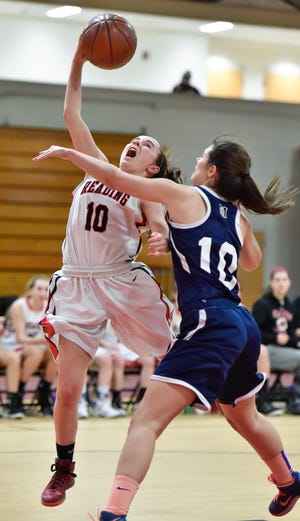 Julia McGurn of the RMHS girls basketball team goes up for two over Medford's Rhiannon Arnold during a game on Feb. 10. Wicked Local Staff Photo / David Sokol