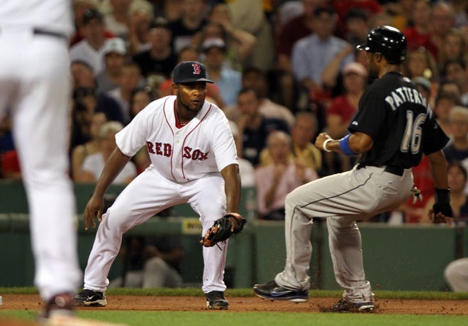 Yamaico Navarro tags out the Blue Jays' Corey Patterson at third base during a 2011 game at Fenway Park.