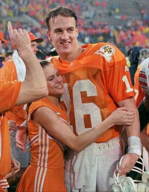 A Tennessee cheerleader hugs Peyton Manning after the Volunteers defeated Ohio State in the 1996 Citrus Bowl.