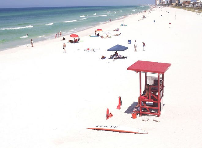 A lifeguard watches beachgoers at the Russell-Fields City Pier in Panama City Beach in 2013. The City Pier, located across from Pier Park, is the only area of the beach in Bay County with lifeguards.