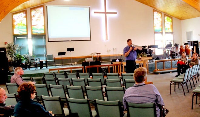 Pastor David Shaw, standing, of the Emmanuel Church of the Nazarene of Wareham, addresses participants in a forum Sunday at the church analyzing new policies adopted by the Board of Health.

Wicked Local Photo/Chris Shott
