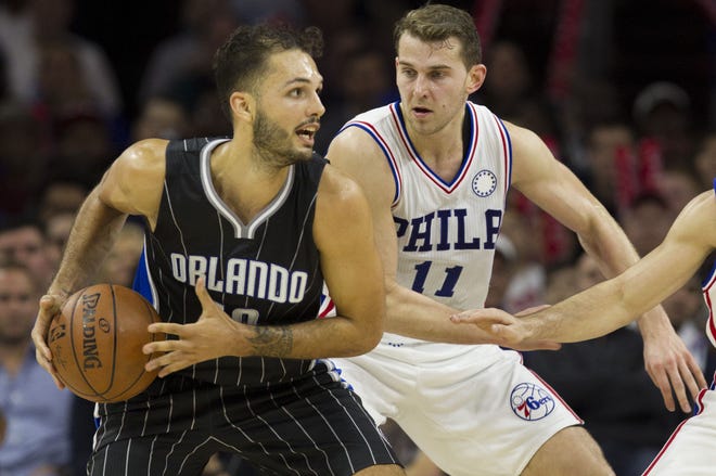 The Magic's Evan Fournier (left) looks to pass as the Sixers' Nik Stauskas (11) defends during a Nov. 7 game.