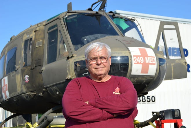 Chuck Brainerd, owner of Firehawk Helicopters, stands in front of the Huey helicopter that will be fully restored and mounted at Veterans Memorial Park in Leesburg last week.