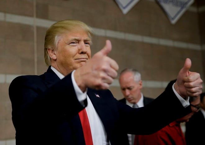 Republican presidential candidate Donald Trump greets supporters at a caucus site Tuesday, Feb. 23, 2016, in Las Vegas. (AP Photo/Jae C. Hong)