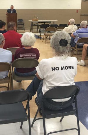 Two protesters donning "No more predators" T-shirts made a brief appearance Tuesday night at a community meeting Savannah Alderman Tony Thomas held at the Crusader Community Center.