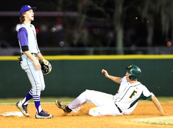 Forest's Hagan Samson slides safely into second base as Gainesville's Kyler Marquis waits on the throw.