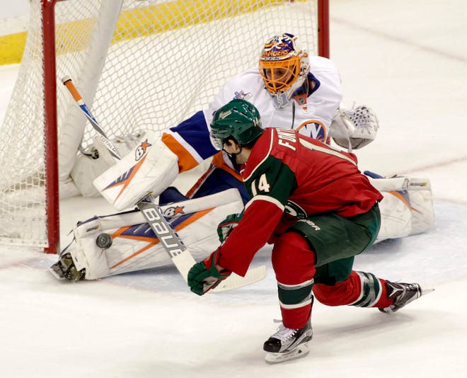 Islanders goalie Jaroslav Halak stops a point-blank shot by Minnesota Wild right wing Justin Fontaine during Tuesday's game in St. Paul, Minn. Associated Press