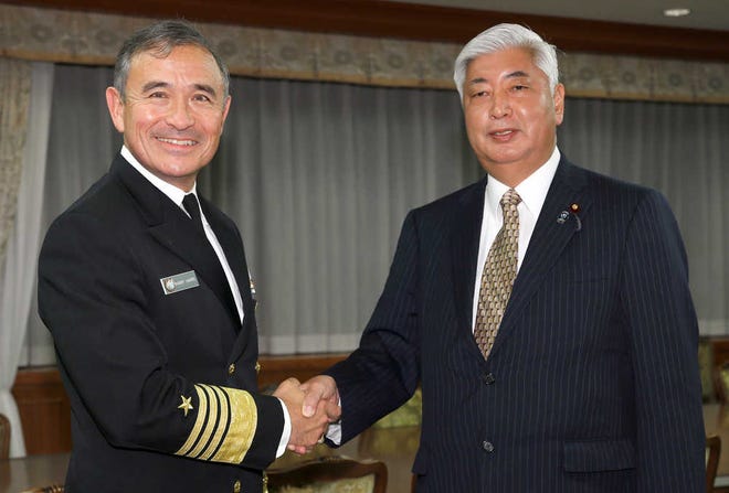 U.S. Navy Adm. Harry B. Harris Jr., left, commander of the United States Pacific Command, poses with Japanese Defense Minister Gen Nakatani prior to their meeting at the Defense Ministry in Tokyo on Wednesday, Feb. 17, 2016.