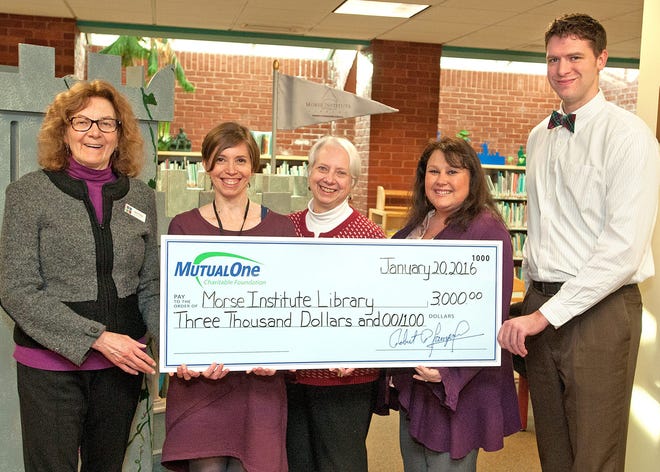 Celebrating the MutualOne Charitable Foundation’s $3,000 grant to the Morse Institute Library, from left: Jane Finlay, assistant director; Anna Litten, community relations coordinator; Dale Smith, children's department supervisor from the Morse Institute Library; Marie Harrington, manager of MutualOne Bank’s Natick office; and Michael Carey, MutualOne Bank’s learning and development coordinator. Courtesy Photo