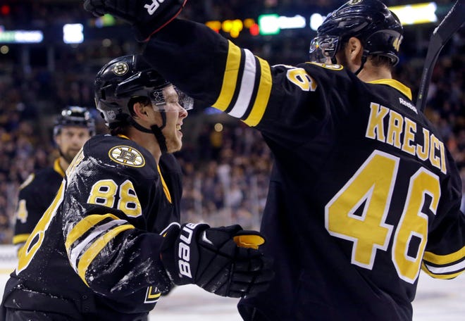 Boston Bruins left wing David Pastrnak (88) celebrates his goal with teammate David Krejci during Wednesday's 5-1 romp of the Pittsburgh Penguins. AP Photo