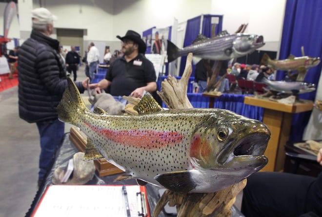 Taxidermist Peter Acampora, of Wallingford, Connecticut, talks to a customer at the 2015 New England Saltwater Fishing Show. The Providence Journal, file / Glenn Osmundson