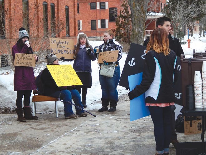 LSSU students hold signs outside the university’s administration building Tuesday morning to protest a series of faculty tenure denials. Organizer Clay Winowiecki said he hoped the protest would push administrators to reconsider the tenure denials and acknowledge a series of faculty grievances.