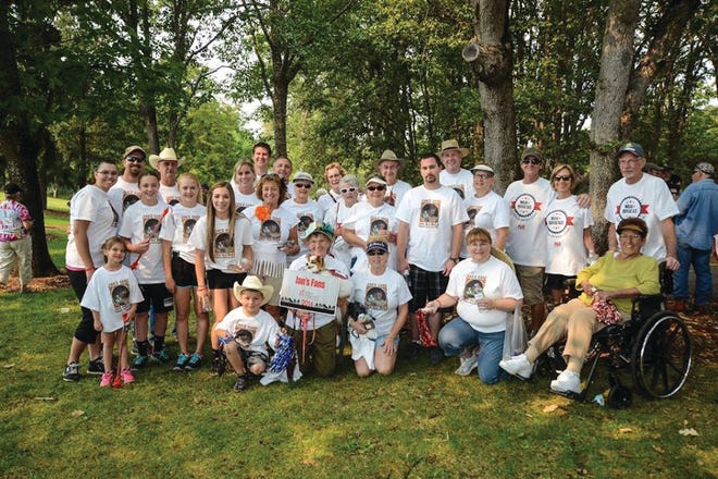 Kayla Buker, pictured above, middle row, fourth from left, with supporters during a recent ALS awareness walk.