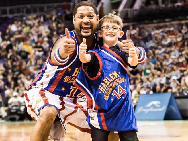 Handles Franklin, shown with a young fan during a previous Harlem Globetrotters game, will perform with the team at 7 Thursdsay night at the O'Connell Center.