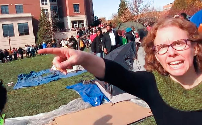 Melissa Click, an assistant professor of mass media at the University of Missouri, demands a journalist leave the Concerned Student 1950 camp area in November. The Missouri Board of Curators voted 4-2 in favor of Click's termination Wednesday during a closed session in Kansas City.