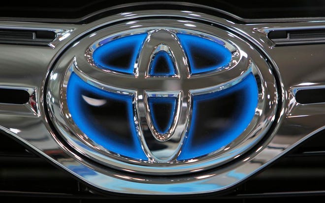 This Thursday, Nov. 10, 2011, file photo, shows the corporate logo of Toyota Motor Corp. on a vehicle on display at the company's showroom in Tokyo. A global recall of nearly 2.9 million Toyota SUVs was prompted by a Canadian investigation into a crash that killed two people. U.S. safety regulators revealed the probe in documents posted Thursday, Feb. 25, 2016. A week earlier, Toyota announced the huge recall because the rear seat belts can be cut in a severe crash. If that happens, the belts won’t restrain passengers. (AP Photo/Junji Kurokawa, File)