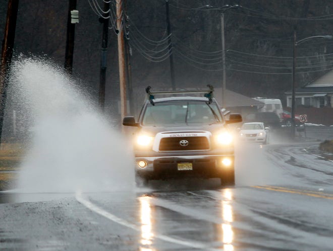 Photo by Tracy Klimek/New Jersey Herald - Vehicles on Route 206 in Andover splash through puddles left by Wednesday's steady rain.
