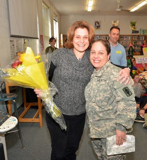 Hampton Academy social studies teacher Suzy Frost gets a surprise visit from Brenda Davis, a sergeant in the U.S. Army National Guard (Kansas division). For several years Frost and her students have been sending care packages to military personnel, and Davis was one of the recipients. They’ve formed a long-distance friendship and Davis surprised her with a visit to Hampton Academy last week.