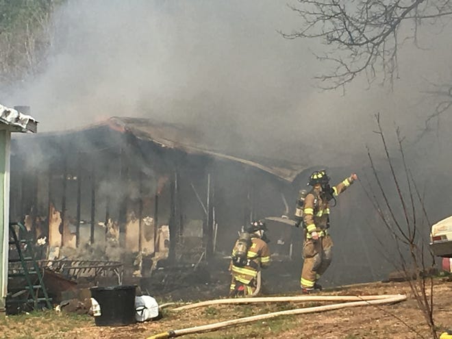Firefighters battle a house fire at 1477 Beachwood Road in Mooresboro. (Joyce Orlando/ The Star)