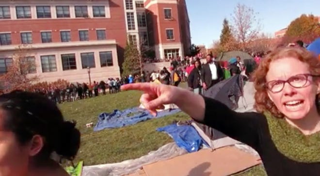 FILE - This Nov. 9, 2015 file frame grab provided by Mark Schierbecker shows Melissa Click, right, an assistant professor in the University of Missouri's communications, is seen during a run-in with student journalists during protests on the Columbia campus. (Mark Schierbecker via AP, File)