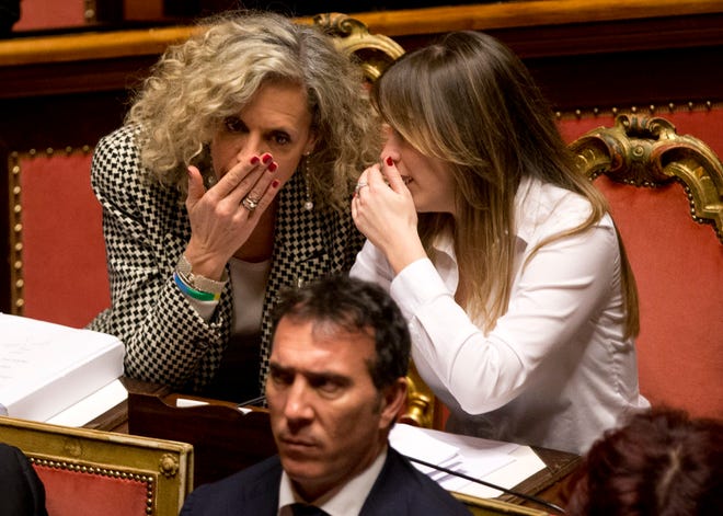 Italian Minister of Constitutional Reforms and Relations with Parliament, Maria Elena Boschi, right, shares a word with senator Monica Cirinna' during a confidence vote in the Italian Senate, in Rome, Thursday, Feb. 25, 2016. Italy's Senate was poised Thursday to grant legal recognition to civil unions, as the last holdout in Western Europe takes a step to give some rights to gay couples after a bitter, years-long battle. (AP Photo/Alessandra Tarantino)