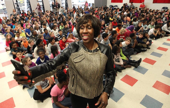 Four-time Olympian Joetta Clark Diggs takes a selfie with students during her visit to Gardner Park Elementary School on Wednesday afternoon. JOHN CLARK/THE GAZETTE