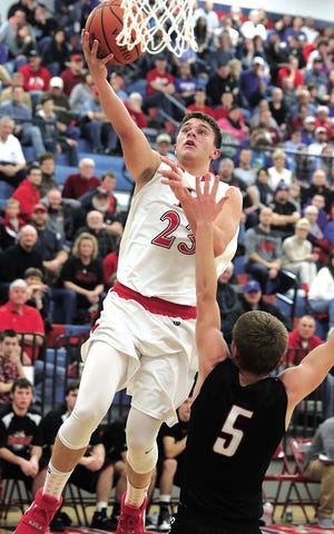 Hiland's Turner Horn drives for a lay up as Tuscarawas Valley's Gabe Shetler defends in Friday's Division III Sectional final at Indian Valley High School. Horn was the Hawks' leading scorer with 14.
