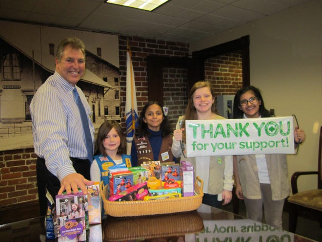 Marlborough Girl Scouts kicked off National Girl Scout Cookie Weekend, Feb. 26-28, with Marlborough Mayor Arthur Vigeant. In the photo, from left: Mayor Vigeant, Daisy Scout Jillian Sjostedt, 7, a member of Girl Scout Troop No. 62471, who has sold 134 boxes of cookies including her favorite, Thin Mints; Brownie Scout Ashwini Menon, 9, a member of Girl Scout Troop No. 78139, who has sold dozens of boxes of cookies including her favorite, Caramel deLites; Ambassador Scout Deanna Doherty, 16, a member of Girl Scout Troop No. 72830, who has sold 200 boxes of cookies including her favorite, Peanut Butter Patties; and Cadette Scout Nishi Kapoor, a member of Girl Scout Troop No. 75240, who has sold many boxes of cookies including her favorite, Thin Mints. WICKED LOCAL PHOTO/MARY WENZEL
