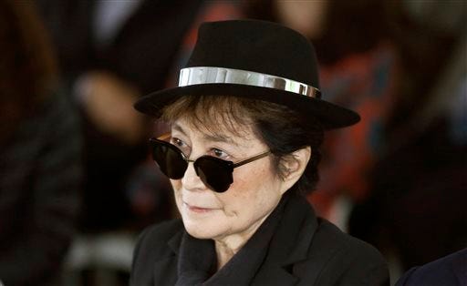 FILE - In a Friday, June 12, 2015 file photo, artist Yoko Ono appears during a ceremony announcing the future installation of Ono's first permanent public art installation in the U.S., in Chicago. Ono was hospitalized Friday, Feb. 26, 2016 for flu-like symptoms, but her representative said the singer was on the mend and should be released soon.